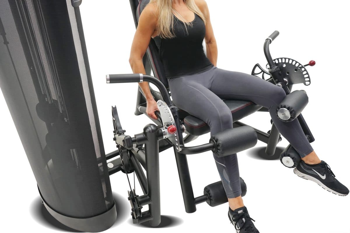 A woman sitting on a gym machine.