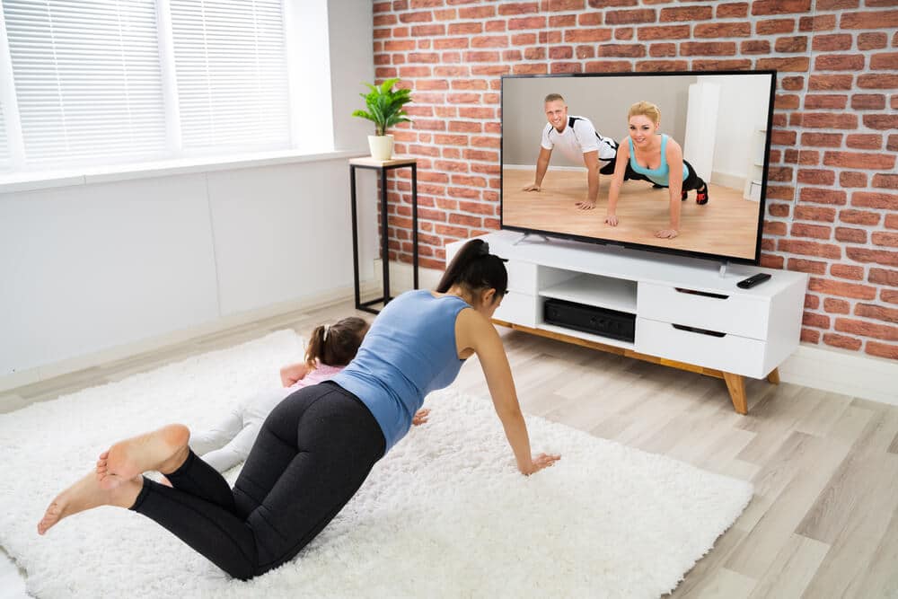 Women exercise with a big TV screen | Fitness Expo