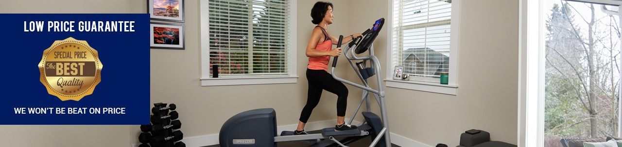 A woman is exercising in a room with a treadmill.