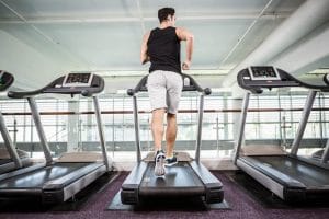 Fit man running on treadmill - Fitness Expo