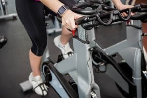 Woman working out on exercise bike - Fitness Expo