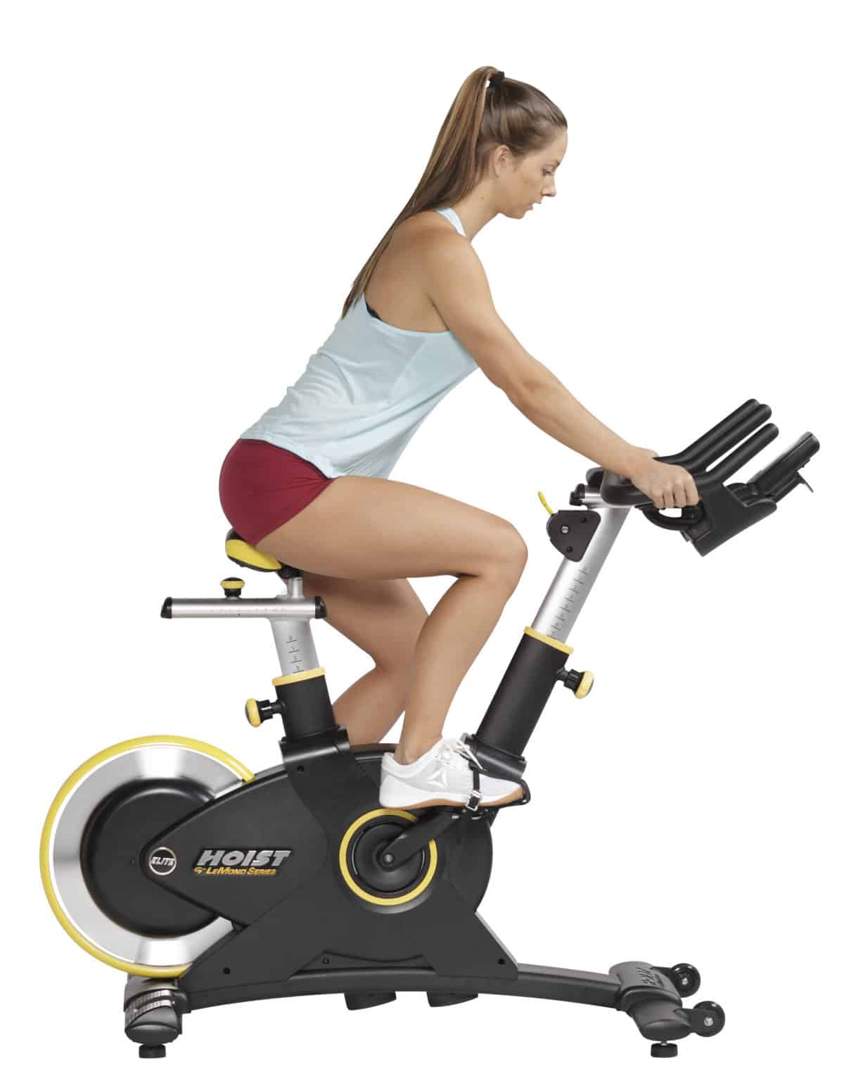 A woman is riding a stationary exercise bike