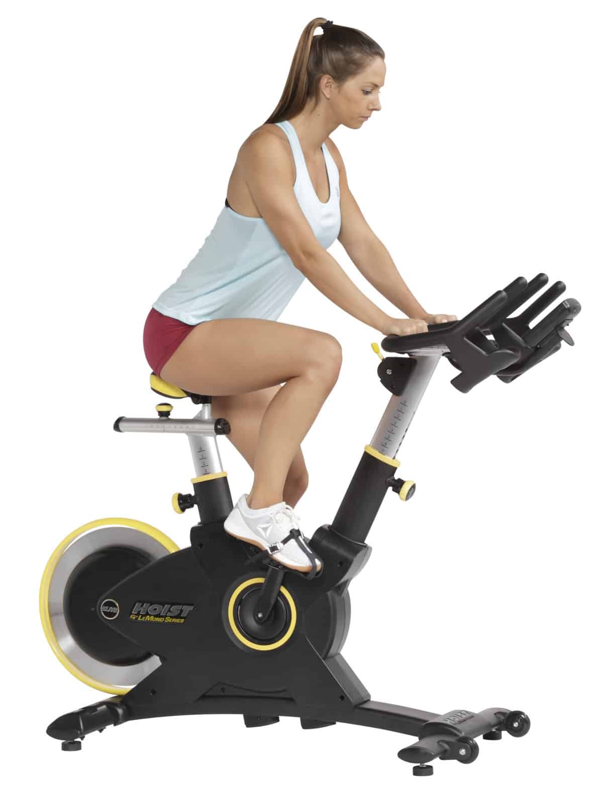 A woman is riding a stationary exercise bike