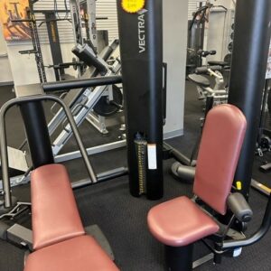 A gym with a variety of machines and equipment.
